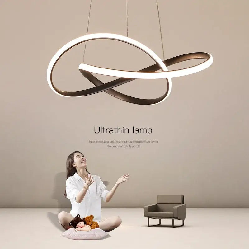 Modern gold infinity loop cord pendant light with sleek white and bronze metallic rings for dining room lighting