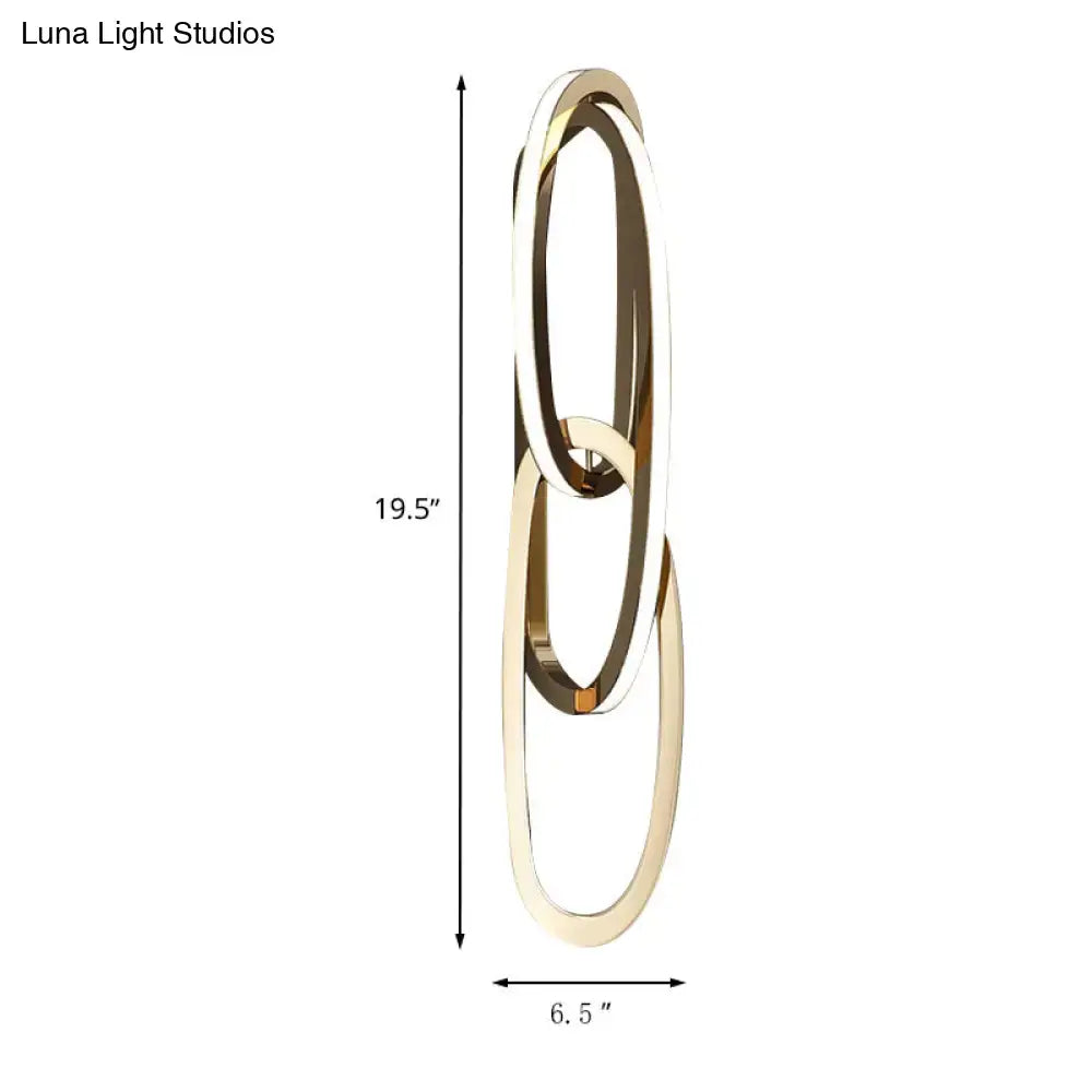 Modern gold wall lamp featuring minimalist interlocking oval rings ideal for living room lighting decor