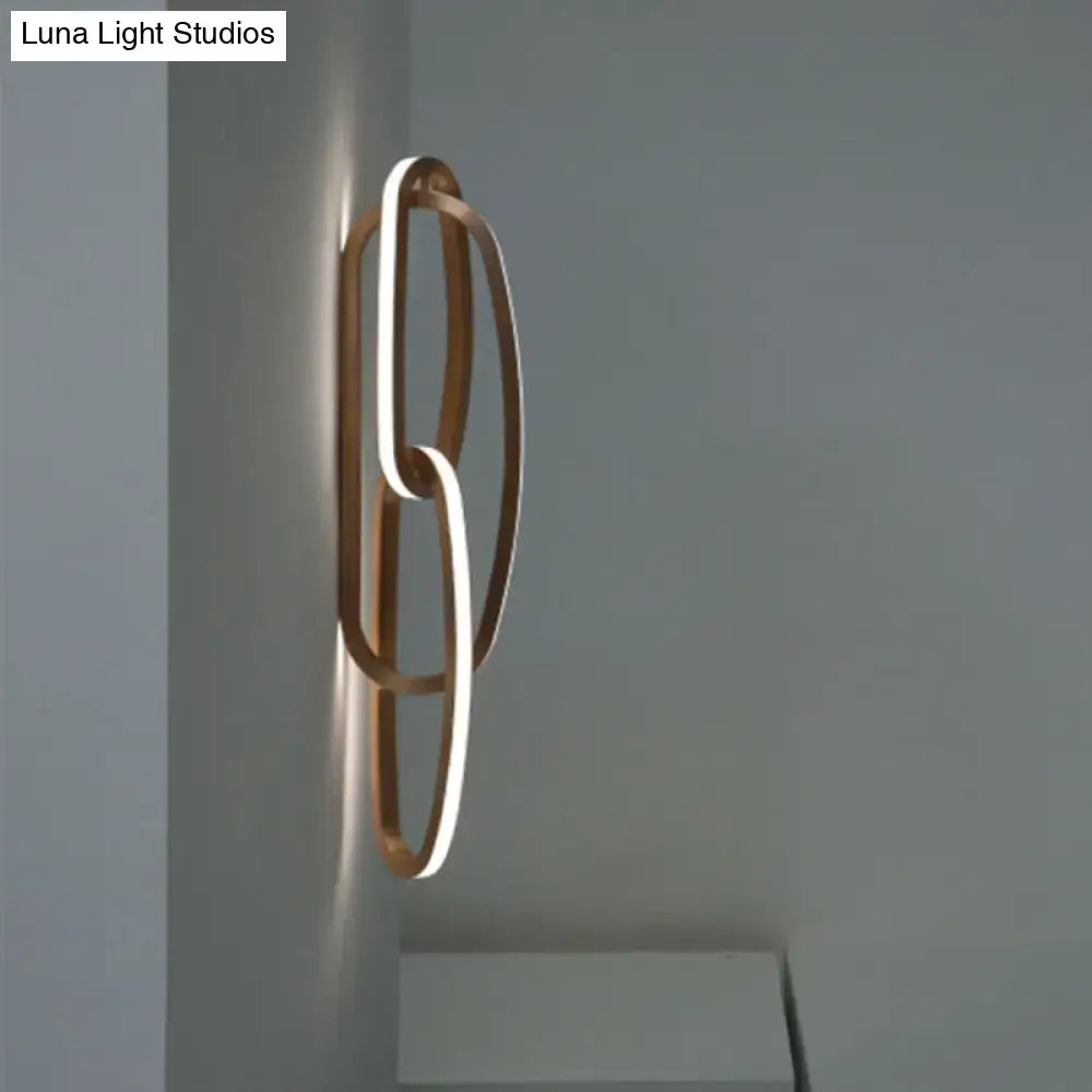 Modern gold interlocking oval led wall lamp with intertwined rings and sleek minimalist design for living room use