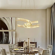 A modern gold pendant light with intertwined circular design and crystal led accents for dining room decorbites crystal led