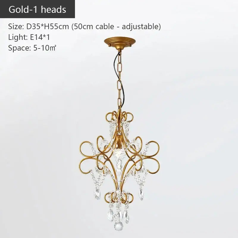Modern gold iron crystal chandelier with intricate scrollwork and dangling crystals for luxury dining room decorbites iron crystal