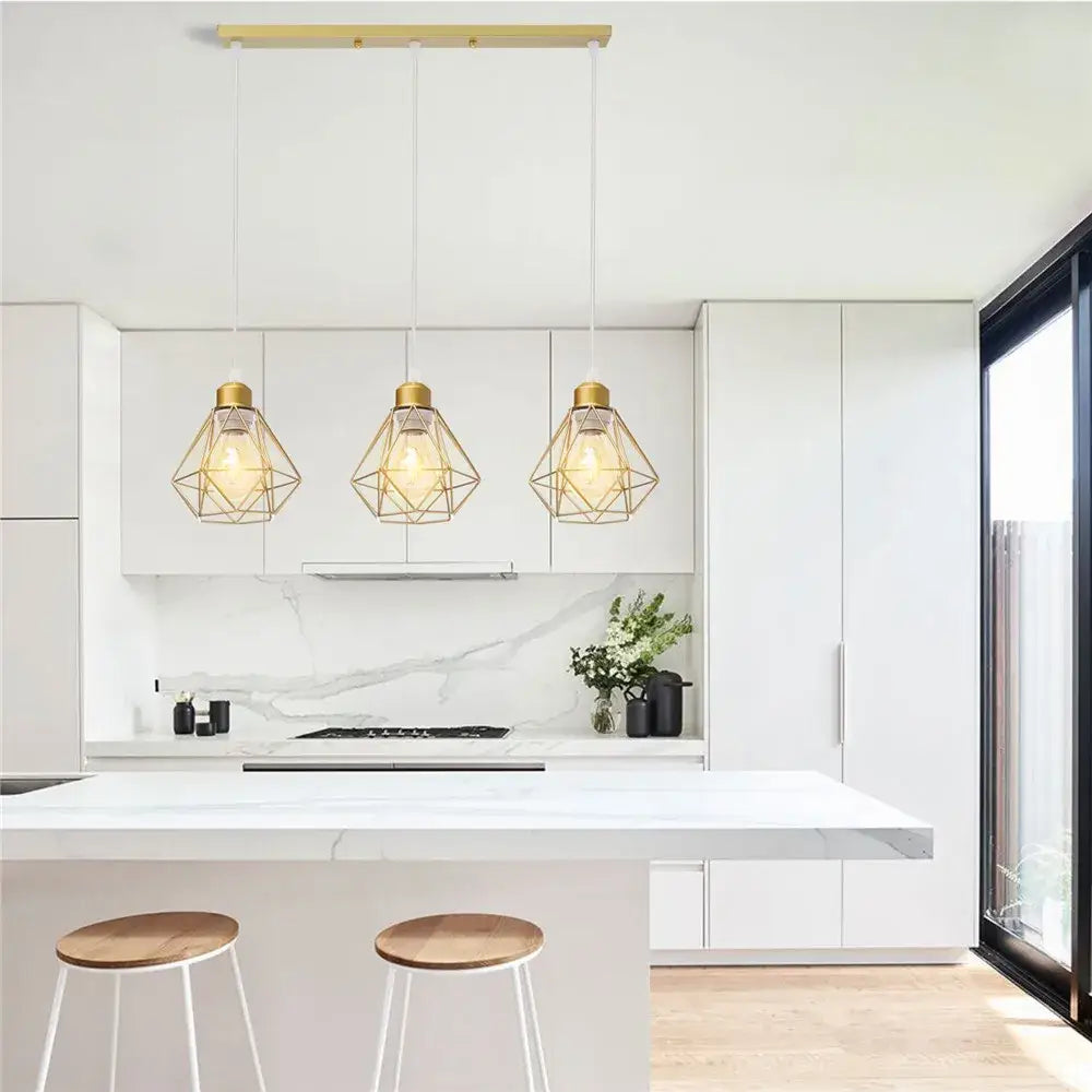 Three modern gold iron frame pendant chandelier lights hang above a white kitchen island for decorbites iron frame decor
