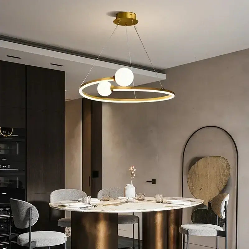Modern gold iron led chandelier light featuring two glowing white bulbs in a sleek circular decorbites iron led frame