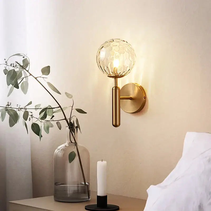 Modern gold iron led sconce lamp with a textured spherical glass globe for bedroom decorbites iron led lighting