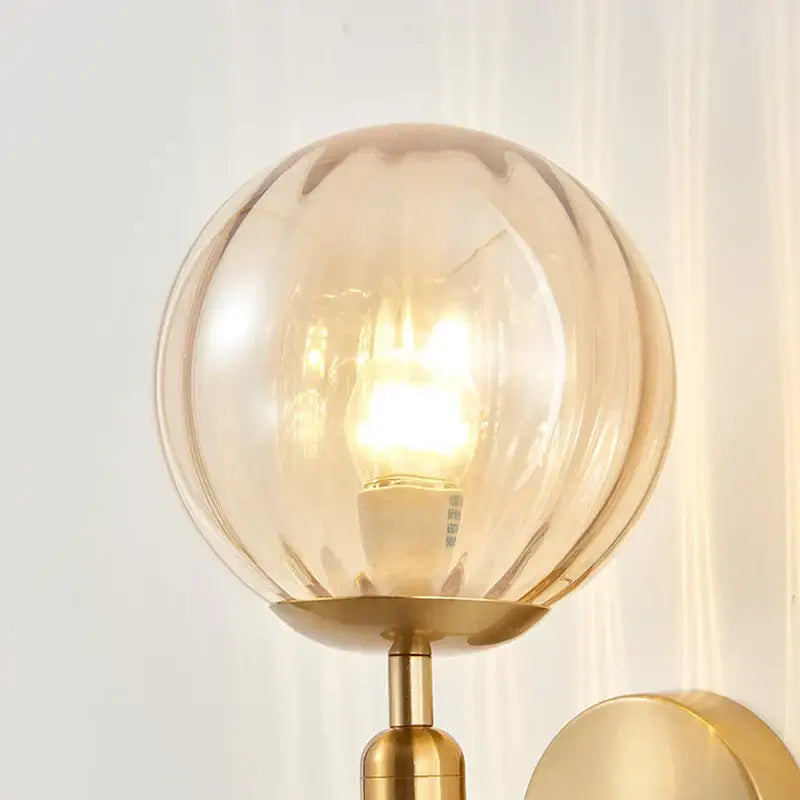 Modern gold iron led sconce lamp with warm-toned textured glass and brass-finished base for bedroom decorbites iron led