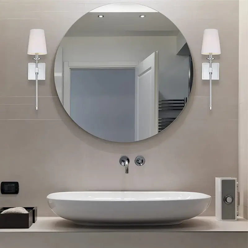 Round white bathroom mirror with chrome fixtures paired with modern gold iron led wall lamp white shade decorbites iron led wall