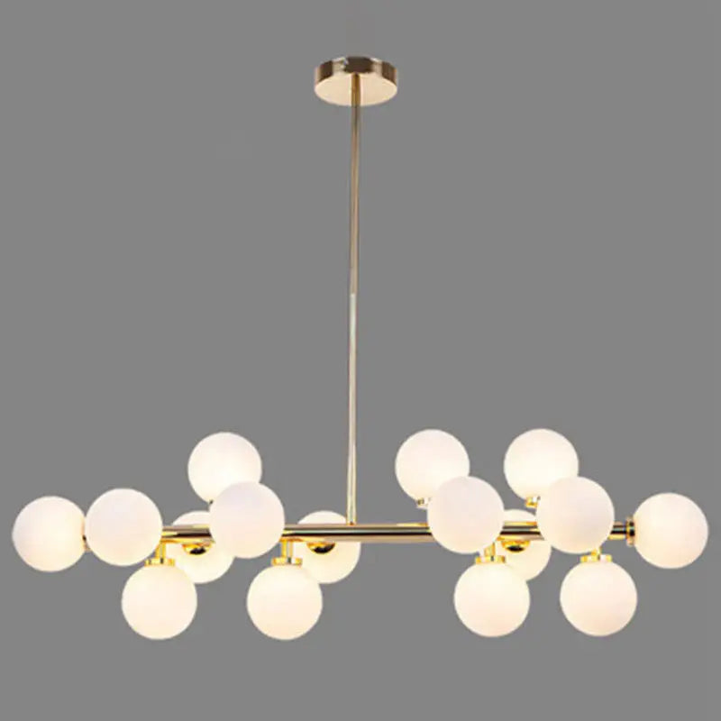 Modern gold island pendant light with frosted glass globe bulbs in a symmetrical branching design for living room