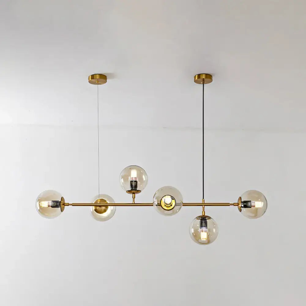 Modern gold island pendant light with brass chandelier design clear glass globe bulbs and black cords for dining room