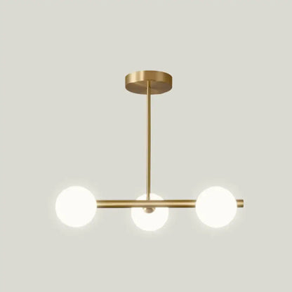 Modern gold island pendant lighting with brass fixture and three frosted glass globe shades for dining room island pendant lighting