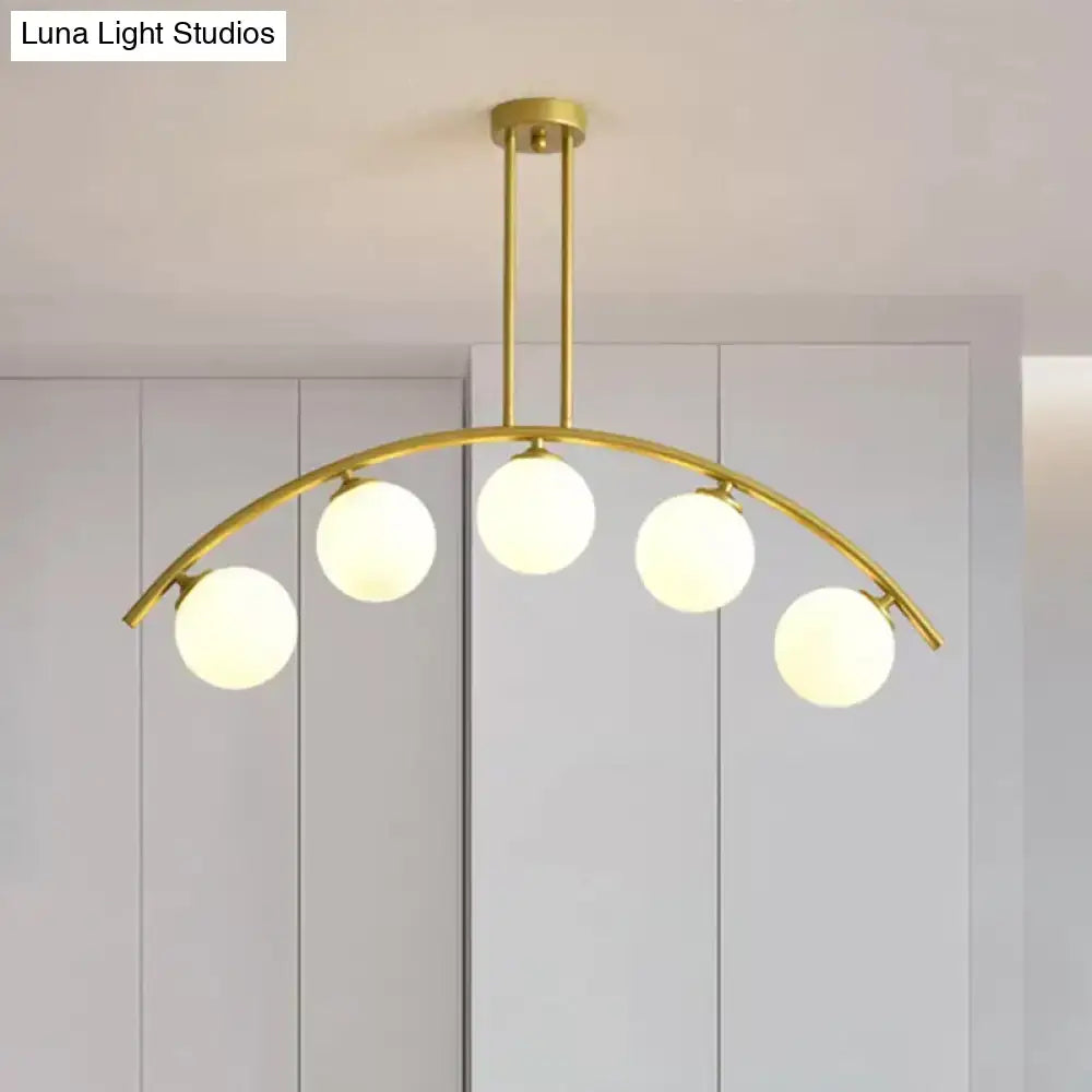 Decorbites gold island pendant with clear white shade featuring five frosted glass globe bulbs in curvy design