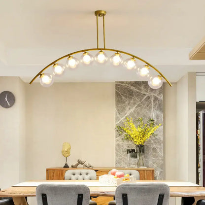 Decorbites gold island pendant with clear white shade featuring gold-toned arches and multiple glass globe bulbs