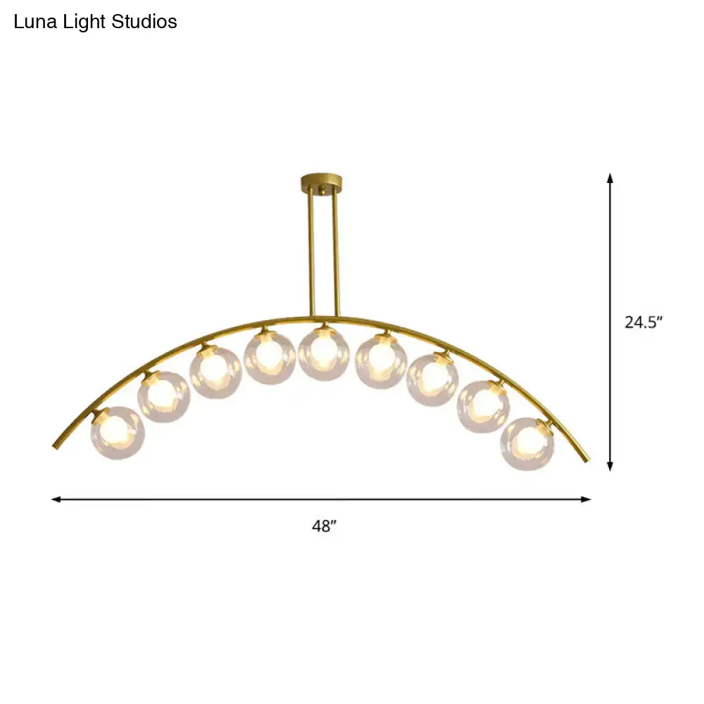 Gold-toned DecorBites island pendant with clear white shade and ten glass globe bulbs for modern kitchen lighting