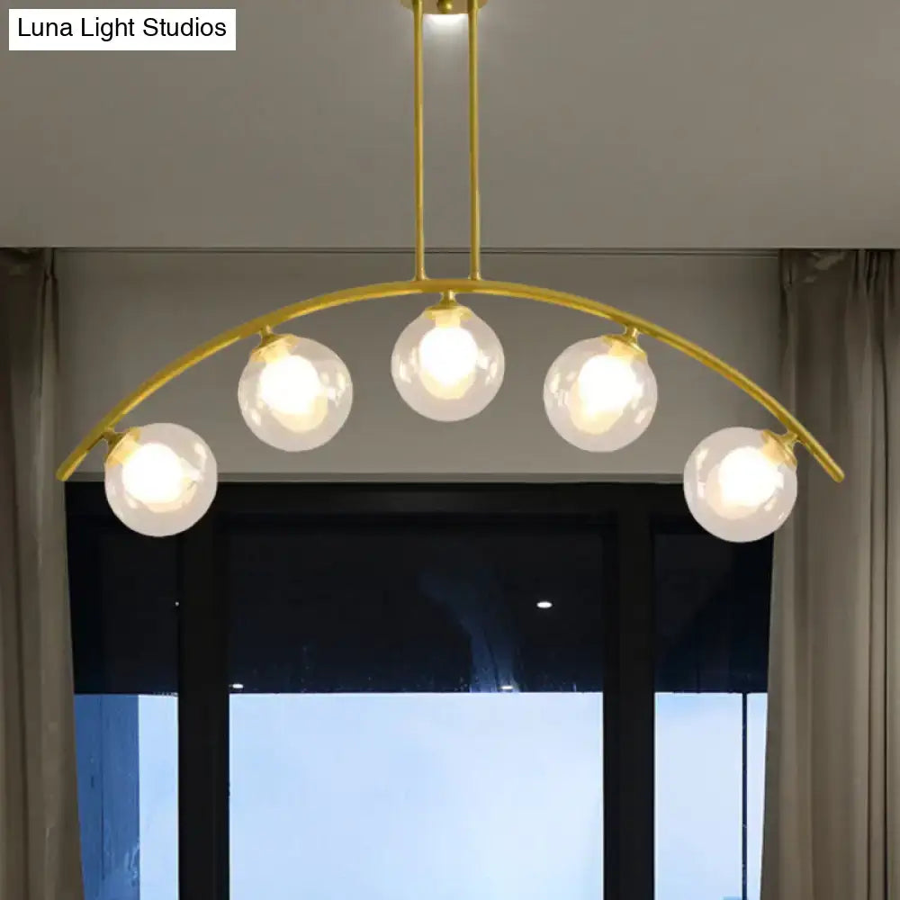 DecorBites gold island pendant with five frosted glass globe bulbs and clear white shade for modern kitchens