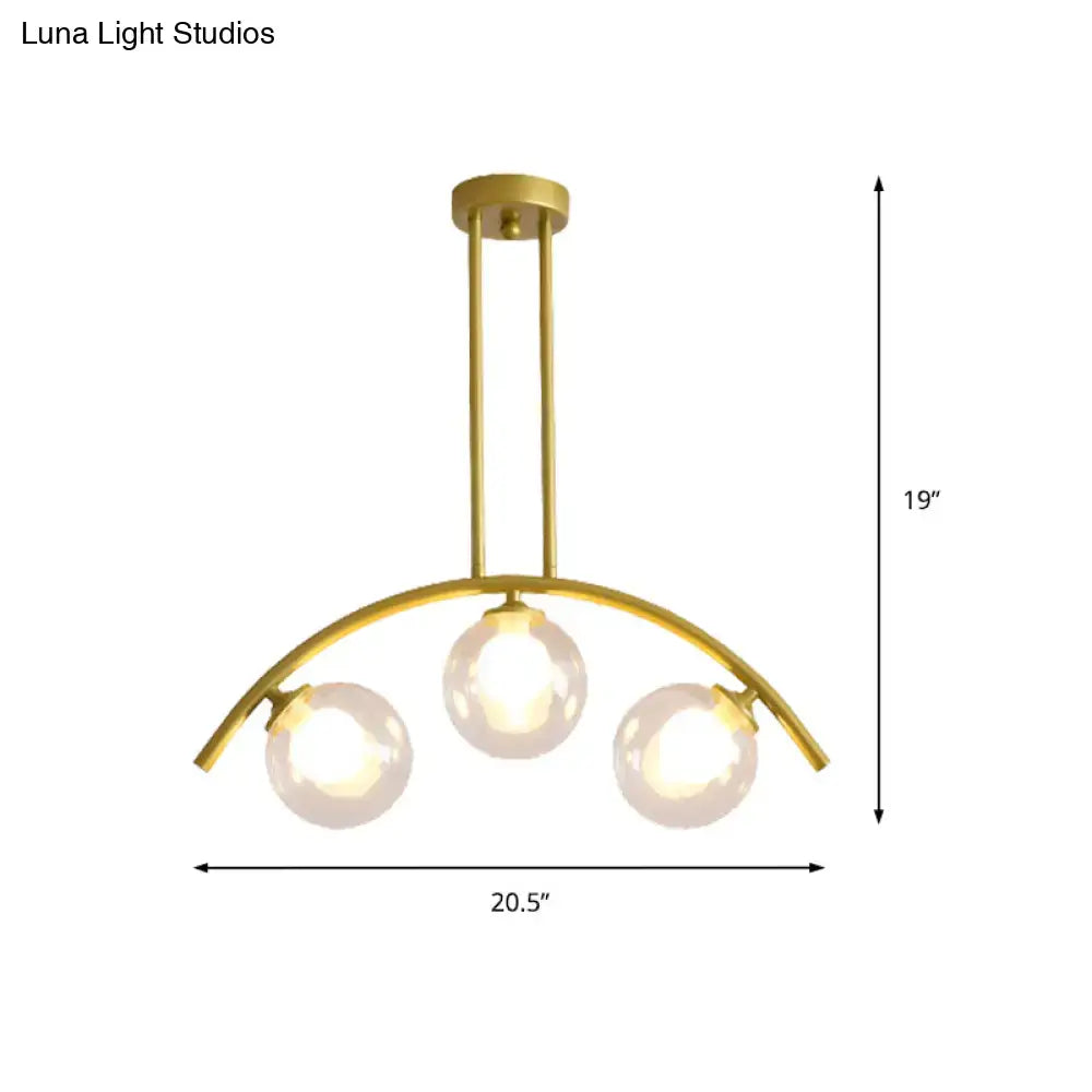 Decorbites gold island pendant with clear white shade features three spherical glass bulbs on a curved metal frame