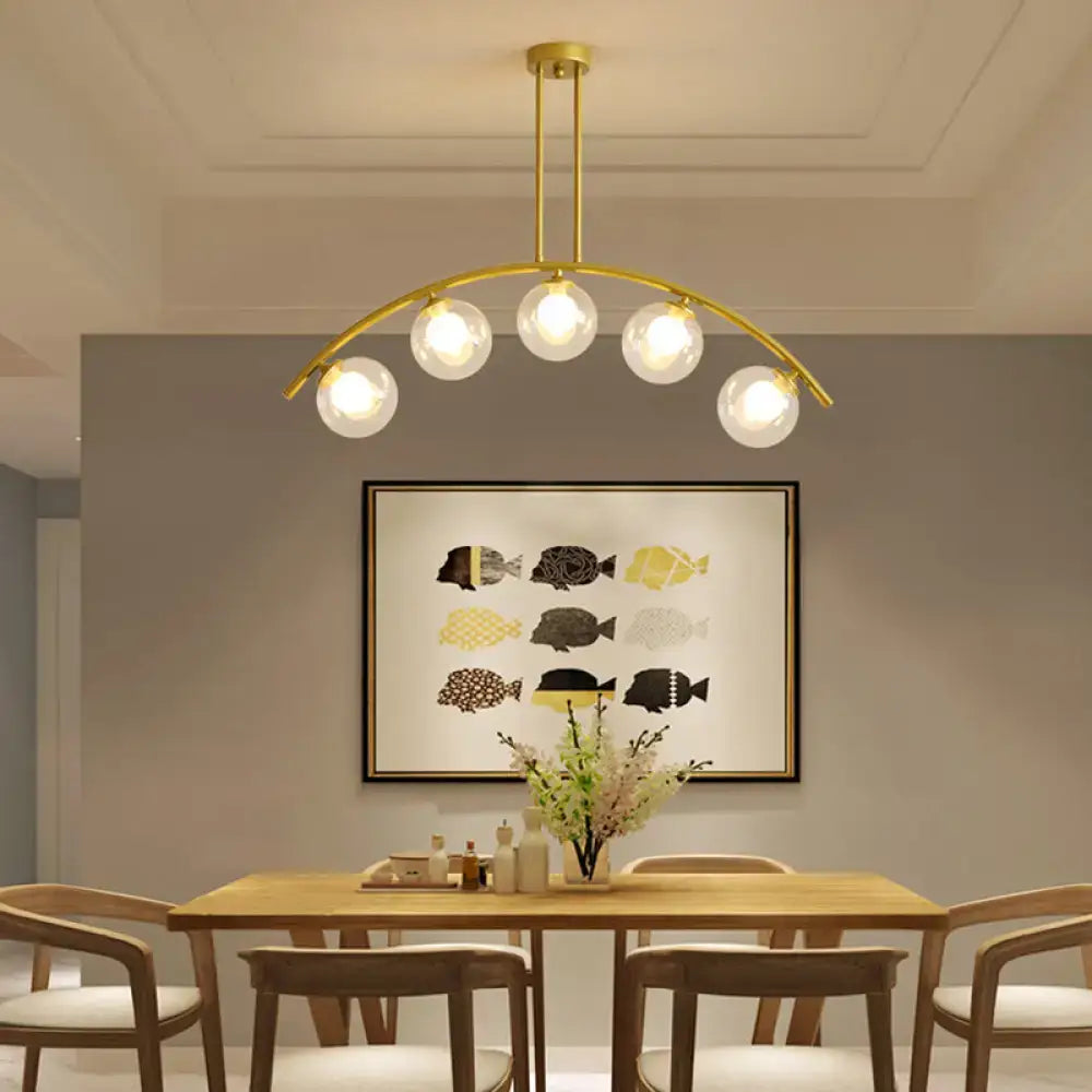 Gold-toned DecorBites island pendant with clear white shade and five glass globe bulbs ideal for modern kitchens
