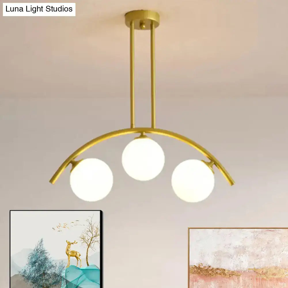 Decorbites gold island pendant with clear white shade and frosted glass globes in curvy modern kitchen design