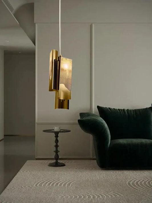 A modern gold-toned pendant lamp with layered geometric design made of decorbites italian marble for dining room decor