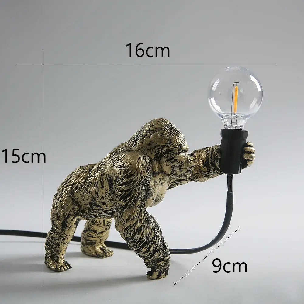 Modern gold king kong resin night light featuring a bronze-finished gorilla figurine with textured fur holding a glass bulb