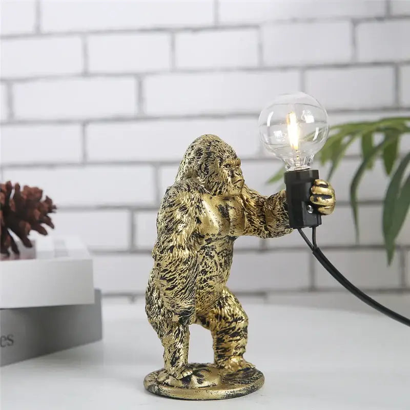 Modern gold king kong resin night light table lamp with textured gorilla figurine holding clear bulb by decorbites king kong
