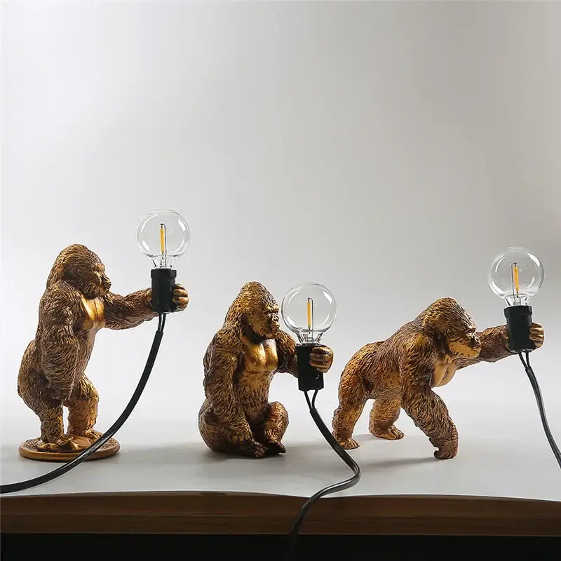 Modern gold king kong resin night light with three golden gorilla figurines holding clear edison bulbs decorbites king kong