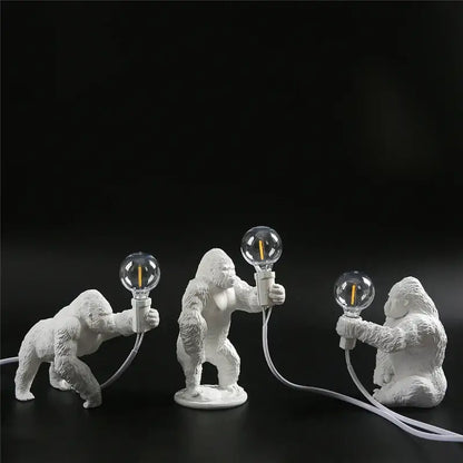 Three white ceramic king kong resin figurines holding glass bulbs in decorbites king kong night light lamp