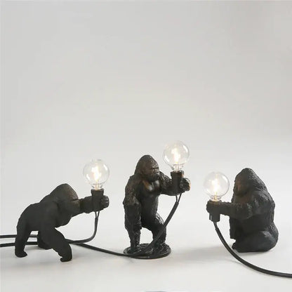 Three black king kong resin night light lamps by decorbites holding lit bulbs for modern bedroom decor