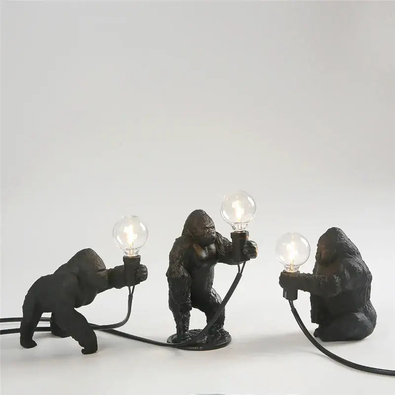 Three black king kong resin night light lamps by decorbites holding lit bulbs for modern bedroom decor