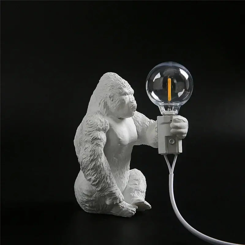 White resin king kong resin night light by decorbites holding a clear glass bulb with orange filament for bedroom decor