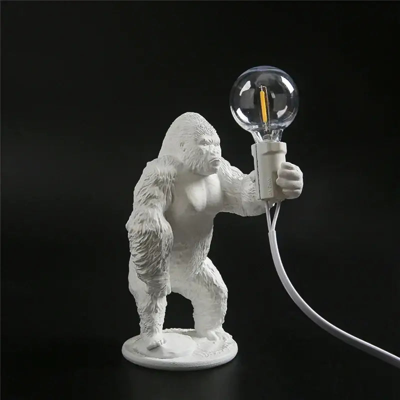 White ceramic king kong resin night light table lamp by decorbites holding a clear glass bulb for modern decor