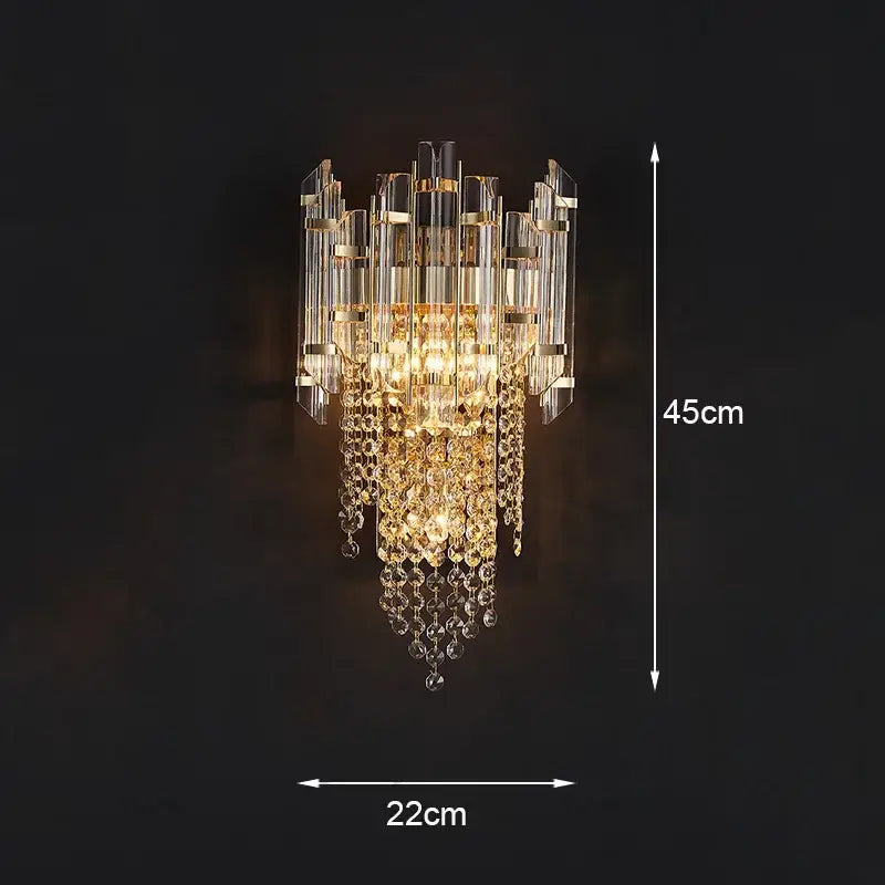 Modern gold wall lamp featuring cascading clear crystal prisms and facets with gold-toned decorbites crystal wall accents
