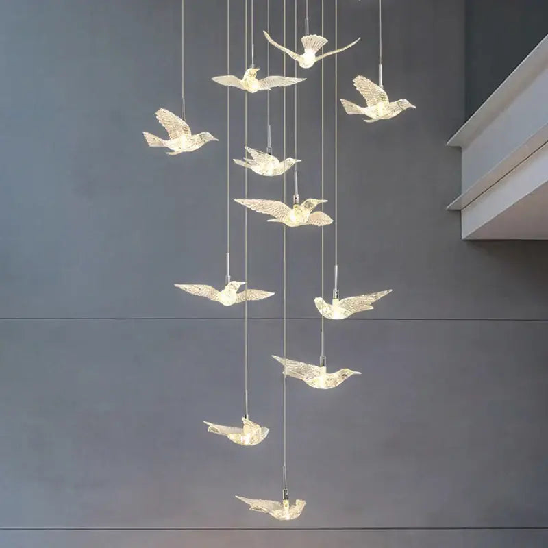 A modern gold led bird pendant light with translucent illuminated bird figures for dining room lighting decorbites led bird pendant