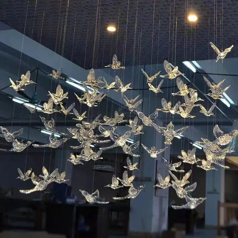 A modern gold led bird pendant light with translucent crystal bird sculptures for elegant dining room decorbites led bird