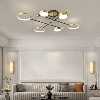 Modern gold led ceiling lamp with black circular base and six illuminated ring bulbs for living room lighting