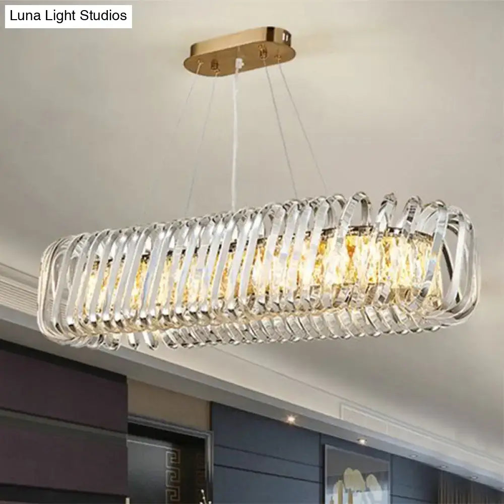 Gold-toned DecorBites™ led island pendant with clear crystal shade featuring elongated rectangular design hanging light fixture
