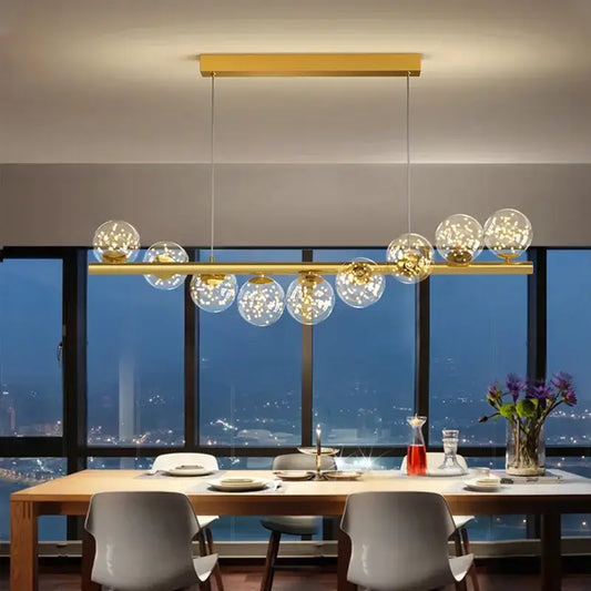 Modern gold led long chandelier with clear glass spheres featuring warm ball g9 led lights for dining room decorbites glass ball pendant light
