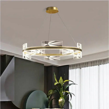 Modern gold led pendant lights featuring a circular chandelier with gold-toned metal frame and acrylic panels