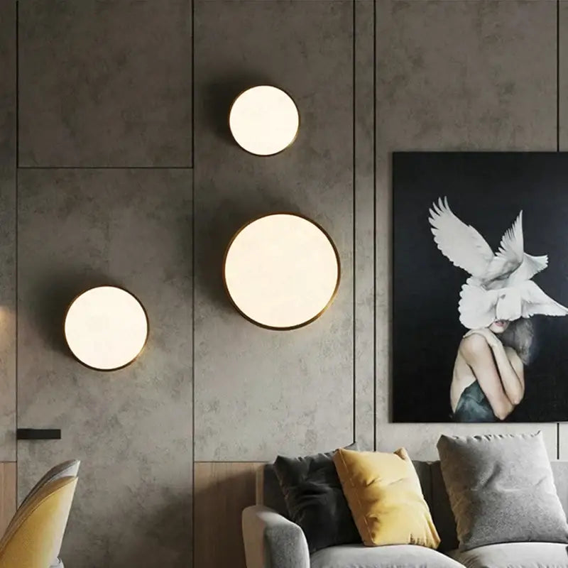 Three modern gold led round ceiling light sconces with warm diffused light and thin gold-toned frames for bedroom