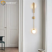 Modern gold led single wall lamp with sleek vertical design and illuminated glass bulb for bedroom decorbites gold led