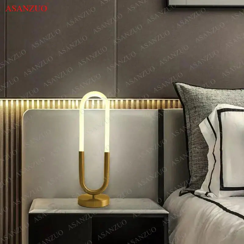 Modern gold-toned led u shape table lamp with sleek design ideal for bedroom art decor and contemporary lighting