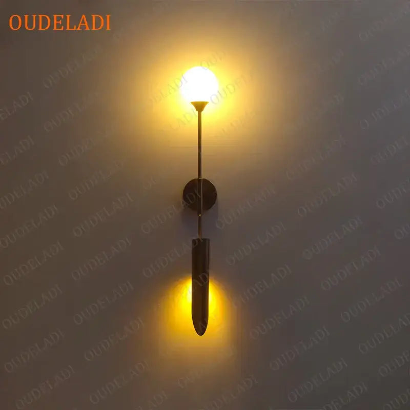 Modern gold led wall lamp with warm-toned brass elongated design and circular mounting plate for living room use