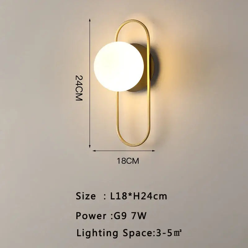 Modern gold led wall lamp with a curved metal frame and round frosted glass globe for living room use