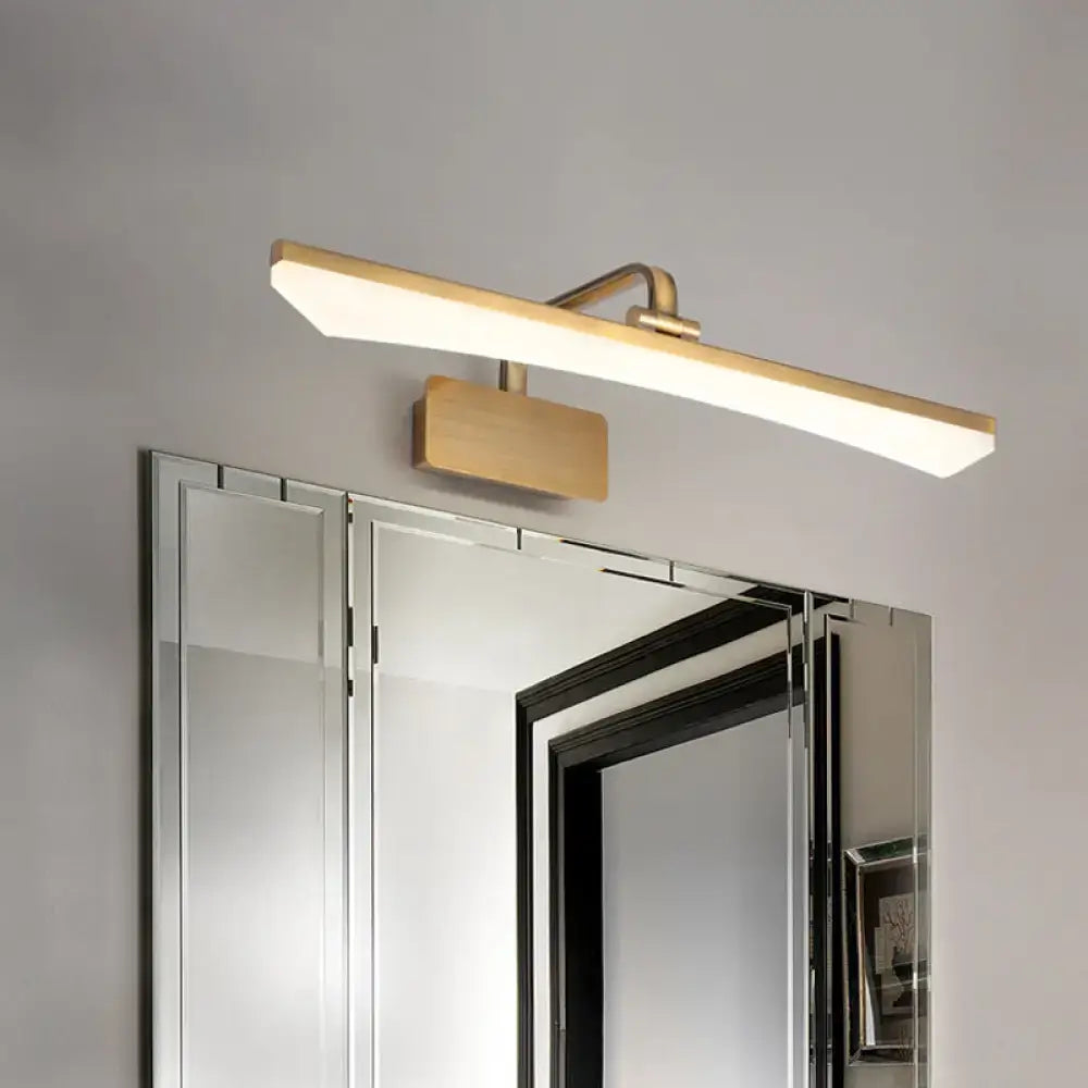 Modern gold-finished rectangular led vanity light with warm white light mounted above a mirrored bathroom cabinet