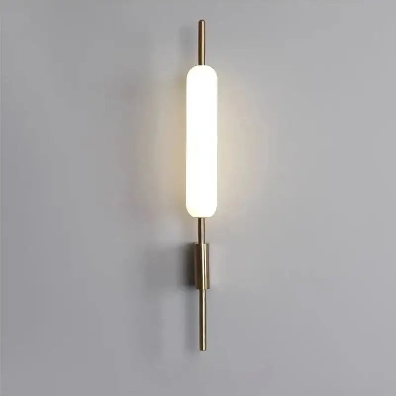 Modern gold led wall light with brass finish and frosted glass diffuser ideal for bedroom wall light illumination