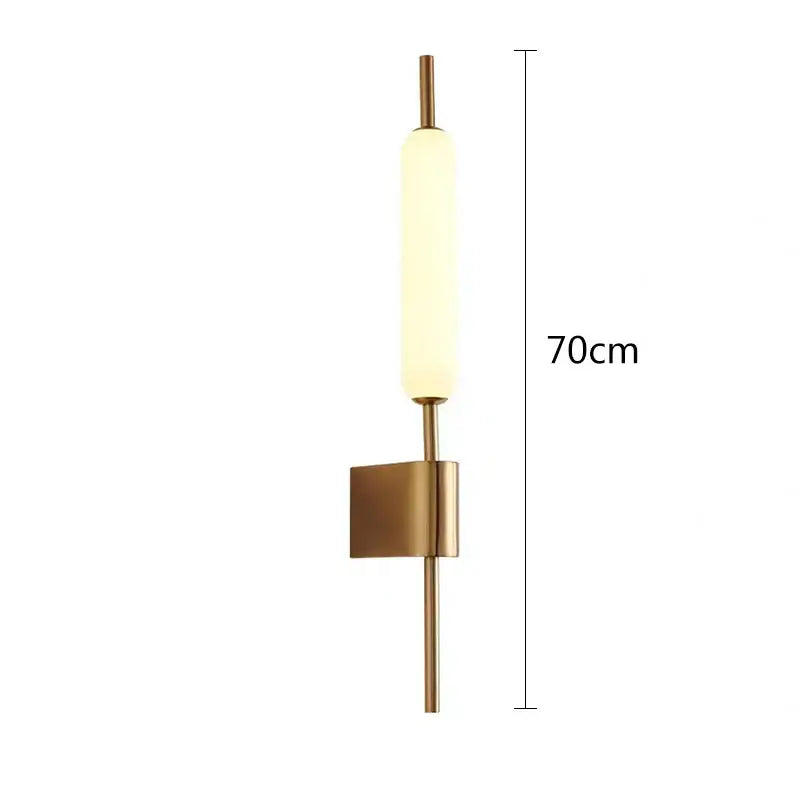 Modern gold led wall light with a brushed brass finish and frosted glass diffuser for bedroom wall lighting