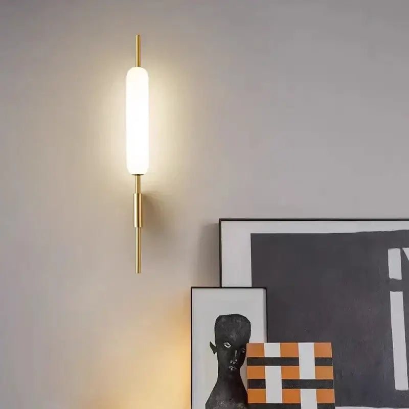 Gold-toned minimalist led wall light with frosted glass diffuser ideal for modern bedroom lighting