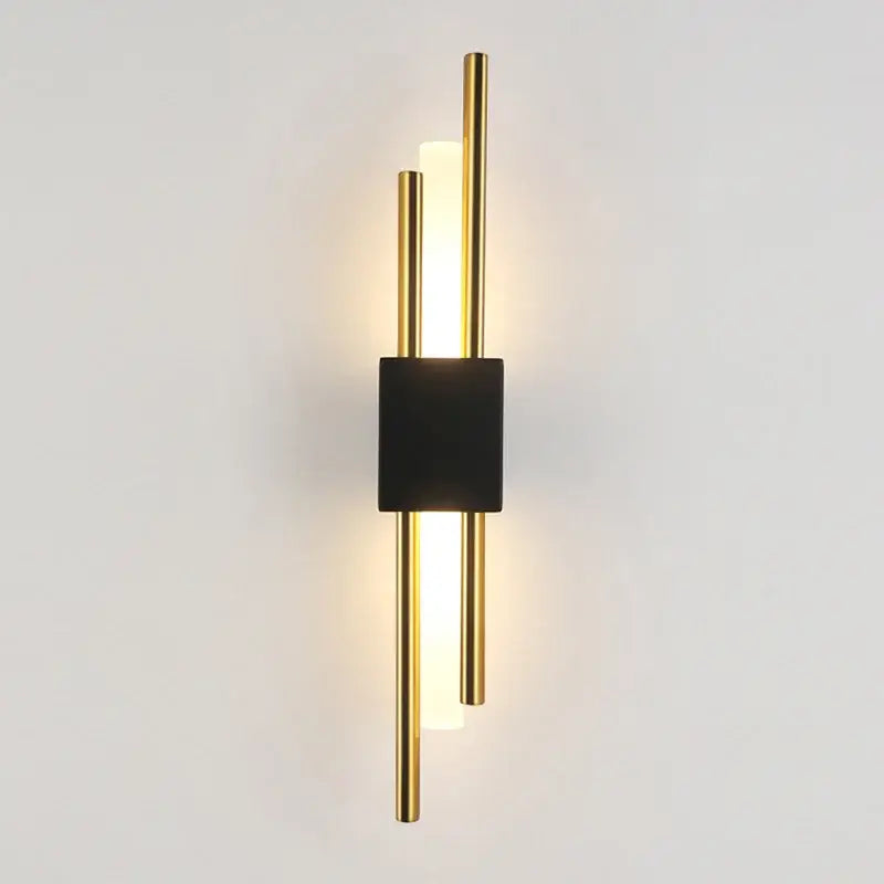 Modern gold led wall sconce with central black square accent and vertical illuminated rods for bedroom ambient lighting