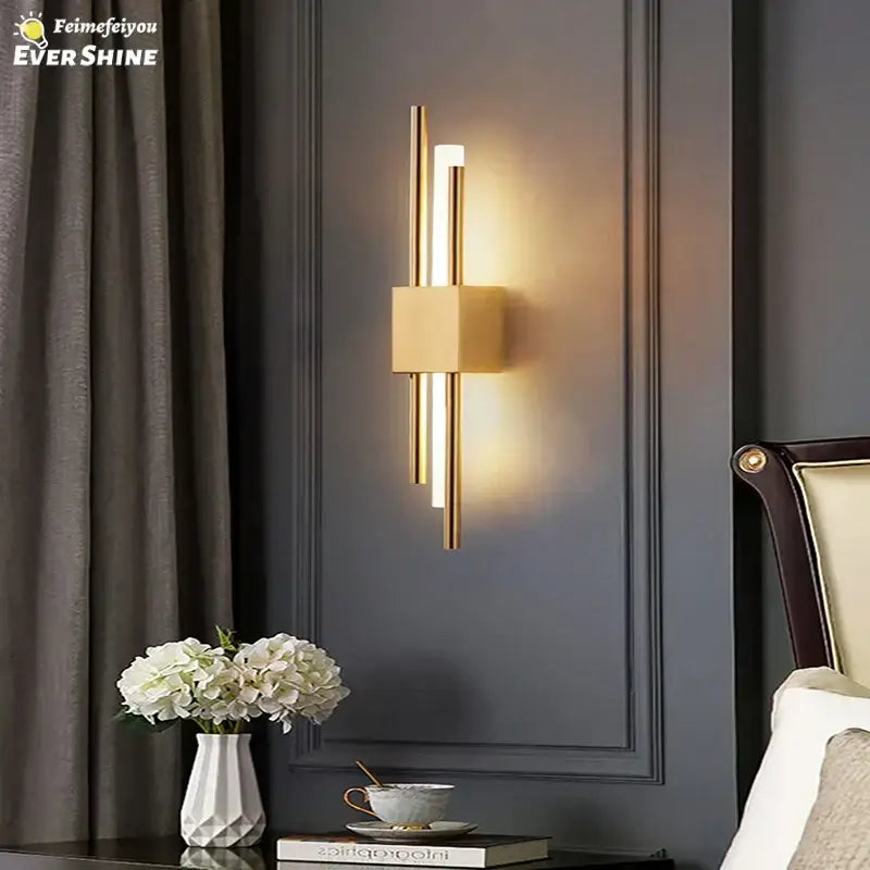 Modern gold led wall sconce with sleek vertical rods and square block for warm bedroom ambient lighting decorbites led wall decor