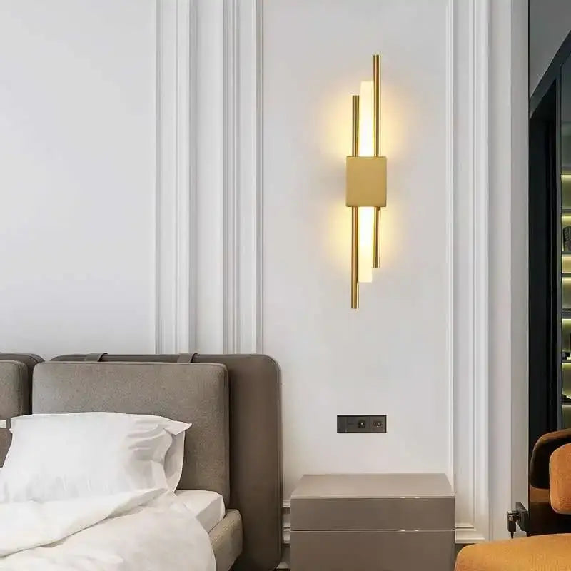 Modern gold led wall sconce with vertical cylindrical rods and rectangular panel for bedroom ambient lighting decorbites led wall