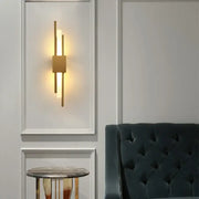 Modern gold led wall sconce with three vertical rods and central panel for bedroom lighting decorbites gold led design