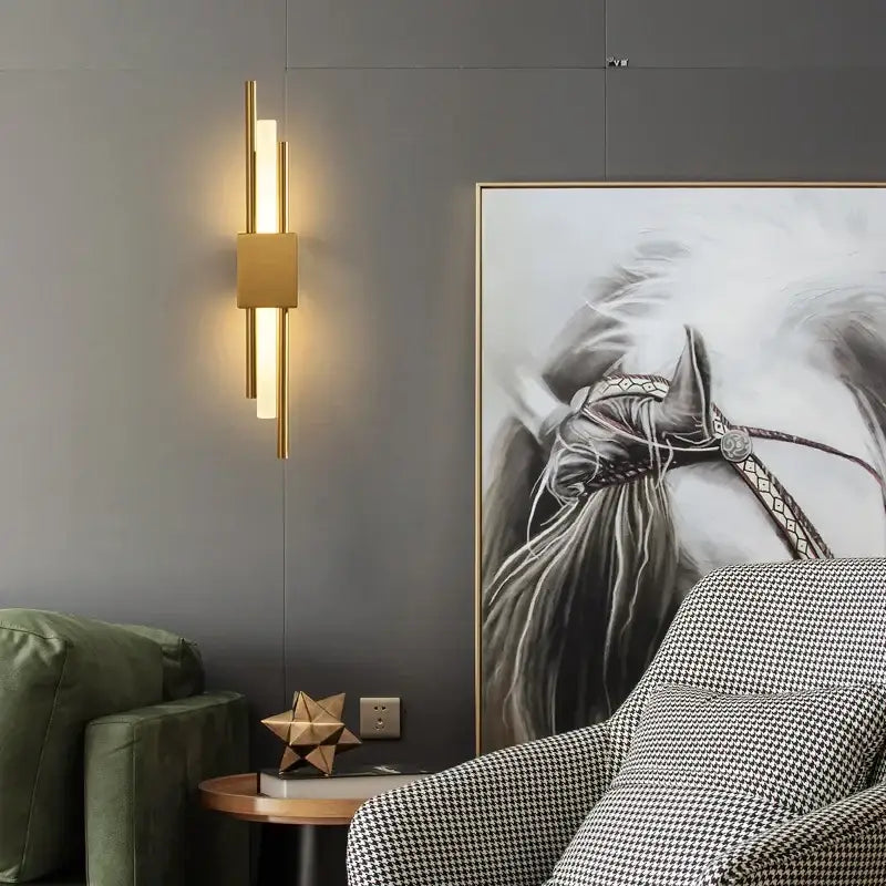 Modern gold led wall sconce with vertical cylindrical bars and central square panel for bedroom lighting decorbites gold led wall